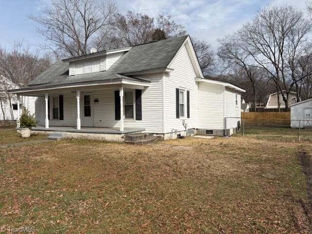 view of front of house with crawl space, covered porch, fence, and a front yard