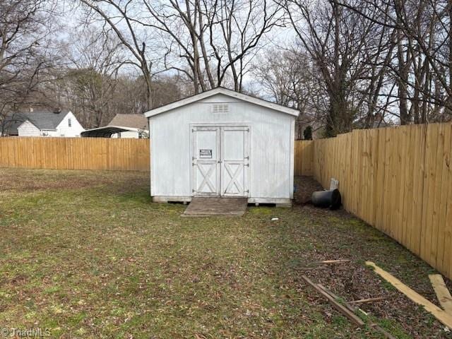 view of shed with a fenced backyard