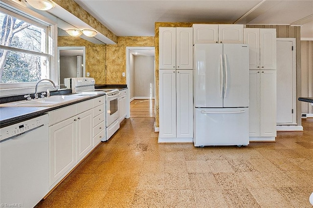 kitchen featuring white cabinetry, white appliances, and sink