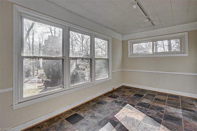 unfurnished sunroom with track lighting