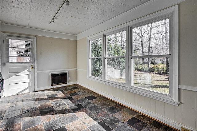 unfurnished sunroom featuring rail lighting and heating unit