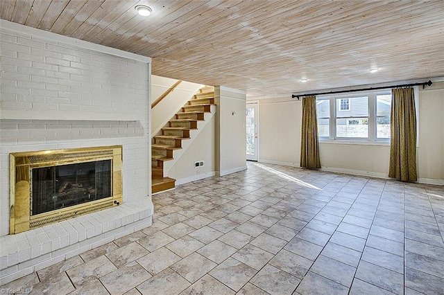 unfurnished living room featuring a fireplace and wood ceiling