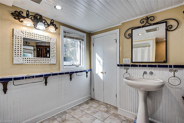 bathroom featuring a shower with curtain, wood ceiling, and ornamental molding