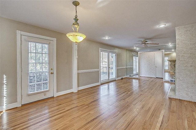 interior space with light hardwood / wood-style flooring and ceiling fan