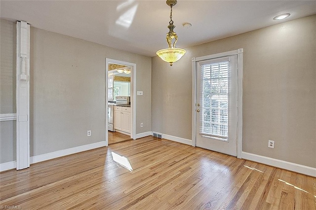 unfurnished dining area featuring hardwood / wood-style floors