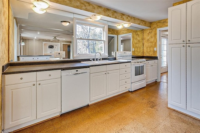 kitchen featuring white cabinets, plenty of natural light, white appliances, and sink