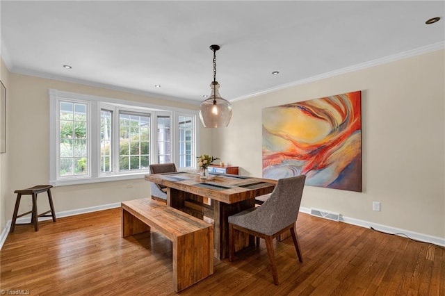 dining room featuring ornamental molding and hardwood / wood-style floors