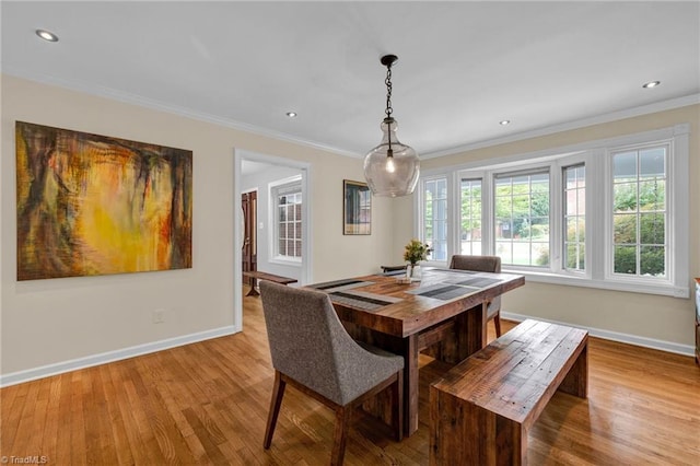 dining room with light hardwood / wood-style floors and ornamental molding