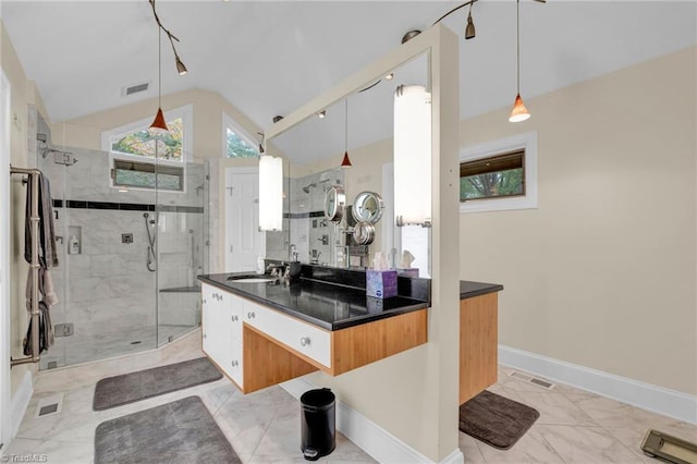 bathroom with vanity, lofted ceiling, and walk in shower