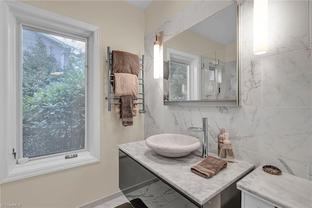 bathroom featuring vanity, a shower, and tile walls