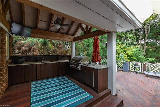 deck with grilling area, an outdoor kitchen, sink, a gazebo, and ceiling fan