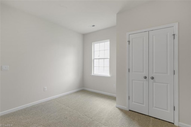 unfurnished bedroom featuring a closet and carpet