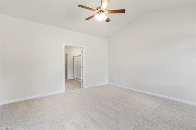 carpeted spare room featuring ceiling fan and lofted ceiling