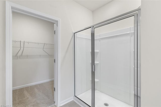 bathroom featuring a shower with shower door