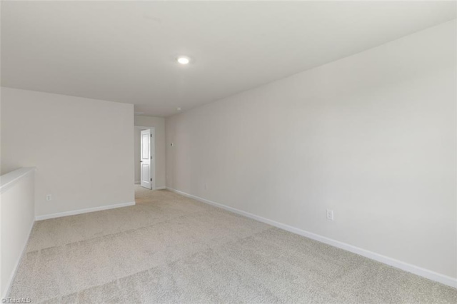 unfurnished room with light carpet