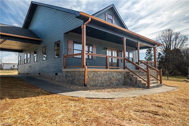 view of front of property featuring covered porch, crawl space, and a front yard