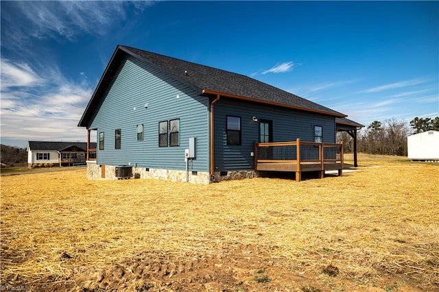 back of property featuring crawl space, a yard, a deck, and central air condition unit