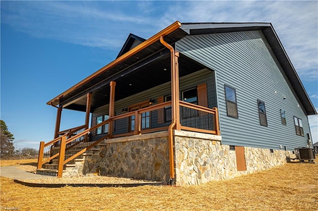 view of side of property featuring cooling unit and crawl space