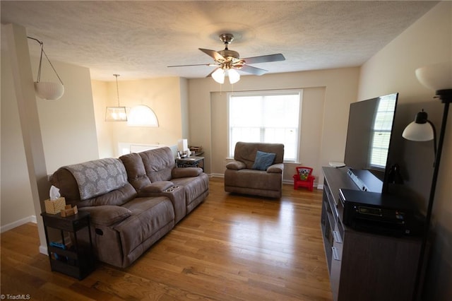 113 Stone Bridge Rd, Mount Airy, NC 27030 - living room featuring a textured ceiling, wood finished floors, ceiling fan, baseboards, and a chandelier