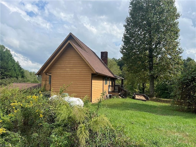 view of home's exterior with a wooden deck and a yard