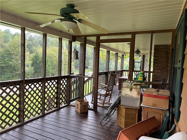 sunroom with ceiling fan and wooden ceiling