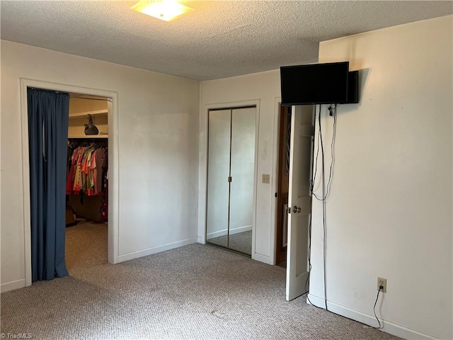 unfurnished bedroom with carpet floors and a textured ceiling