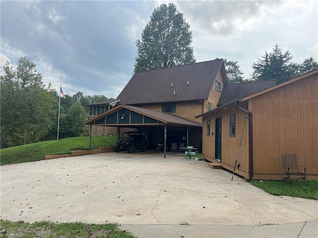 exterior space with a lawn and a carport