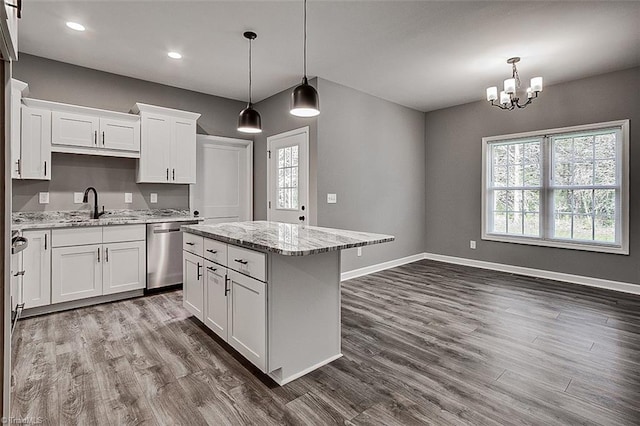 kitchen with white cabinetry, dishwasher, a sink, dark wood-style flooring, and a notable chandelier