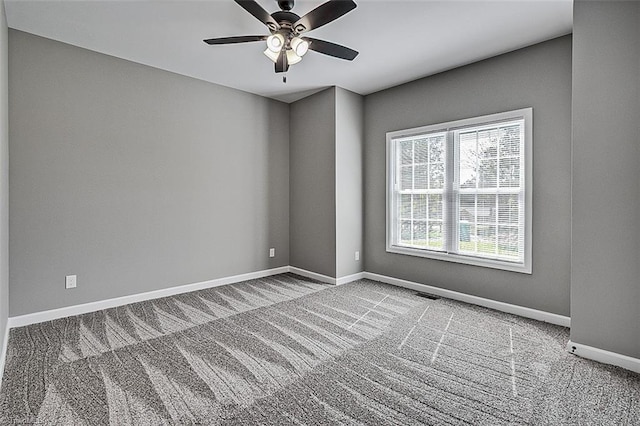 empty room featuring carpet floors, baseboards, and ceiling fan