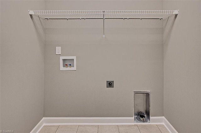 washroom featuring tile patterned floors, electric dryer hookup, laundry area, and baseboards