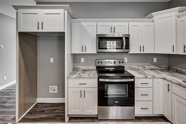 kitchen featuring white cabinets, appliances with stainless steel finishes, and baseboards