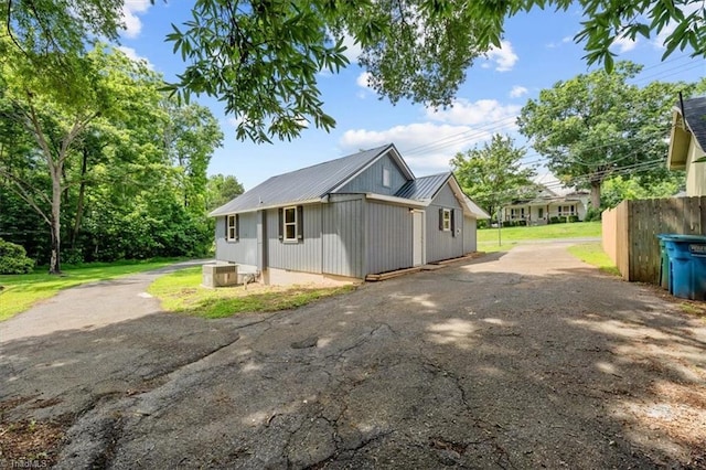 539 W Salisbury St, Denton, NC 27239 - view of property exterior featuring a metal roof and asphalt driveway