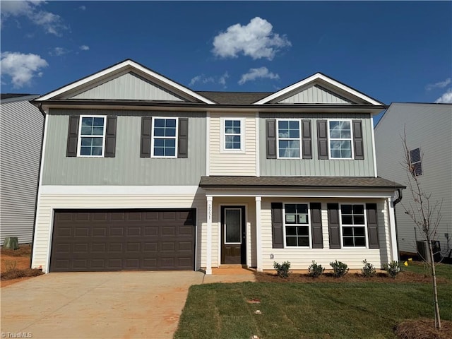 2551 Raspberry Hill Dr, Winston-Salem, NC 27106 - view of front of house featuring concrete driveway, a front lawn, a garage, and a shingled roof