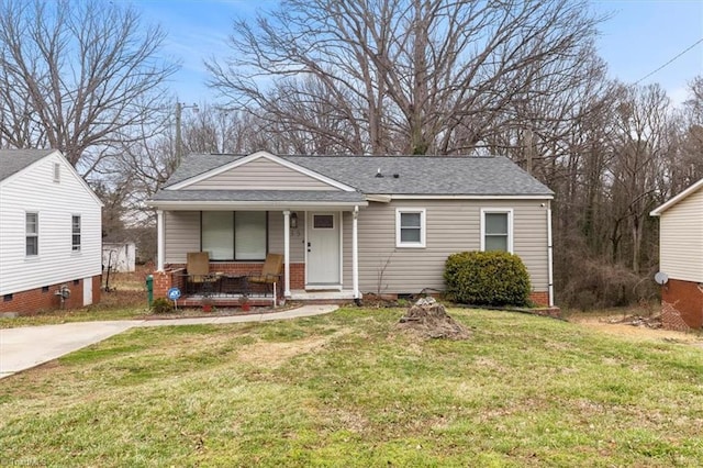 bungalow-style house featuring a porch, a front yard, and roof with shingles