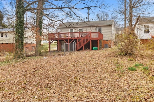 rear view of house with stairway, a wooden deck, central AC, and fence