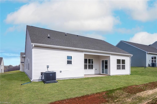 back of property with a yard, a patio, and central AC