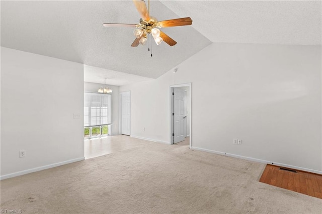 189 Lochshire Ln, Woodleaf, NC 27054 - carpeted spare room featuring a chandelier, a ceiling fan, high vaulted ceiling, and a textured ceiling