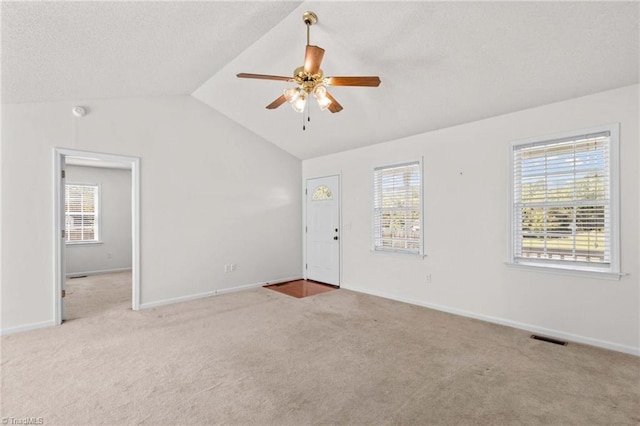 189 Lochshire Ln, Woodleaf, NC 27054 - spare room with ceiling fan, carpet floors, healthy amount of natural light, vaulted ceiling, and a textured ceiling