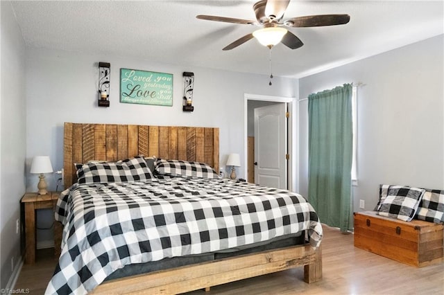 bedroom with ceiling fan and wood finished floors