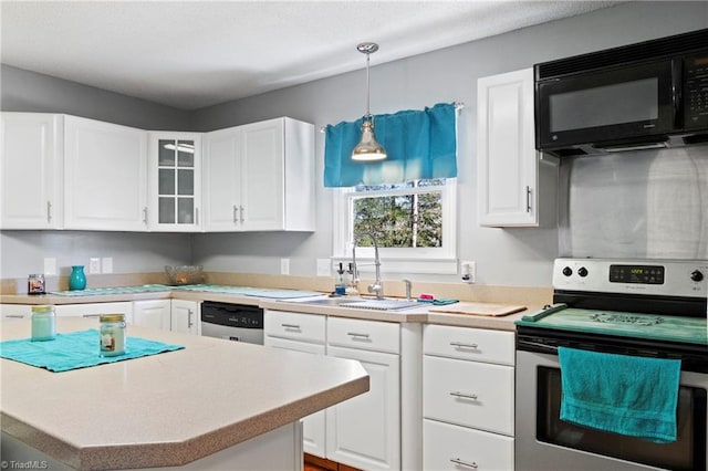 kitchen featuring white cabinetry, appliances with stainless steel finishes, light countertops, and a sink