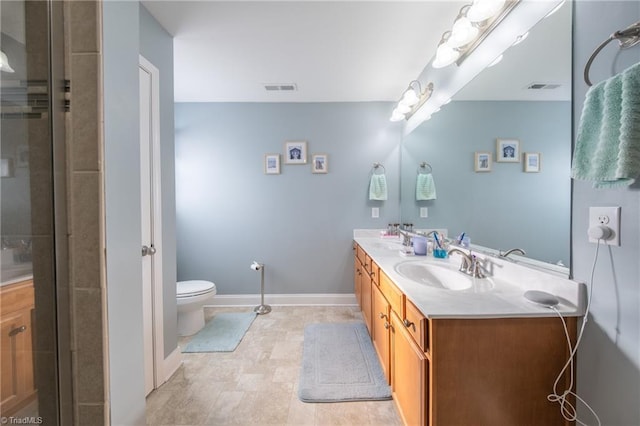 bathroom with vanity, toilet, and a shower with shower door