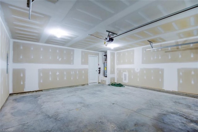 garage with a garage door opener and water heater