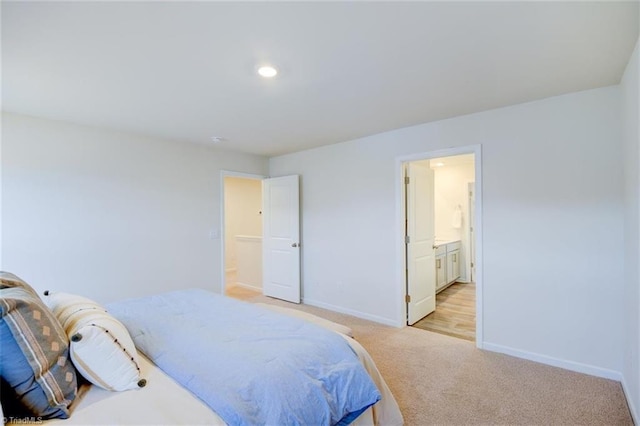 carpeted bedroom with ensuite bathroom