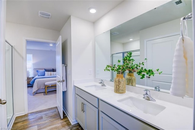bathroom featuring vanity, hardwood / wood-style floors, and an enclosed shower