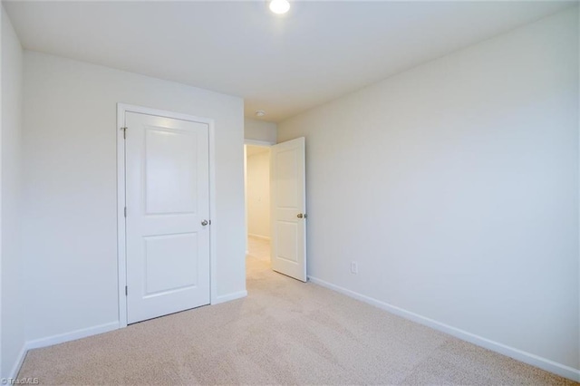unfurnished bedroom with light carpet
