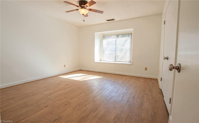 spare room featuring hardwood / wood-style flooring and ceiling fan