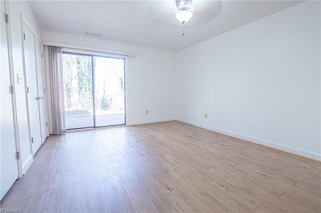 empty room featuring ceiling fan and light hardwood / wood-style flooring