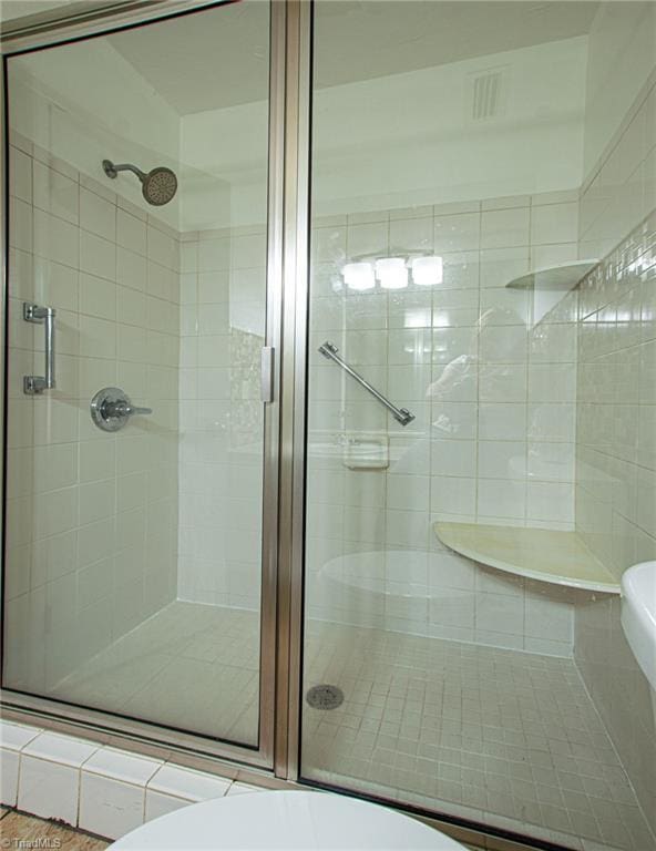 bathroom with a shower with shower door