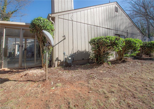 view of side of property featuring a sunroom