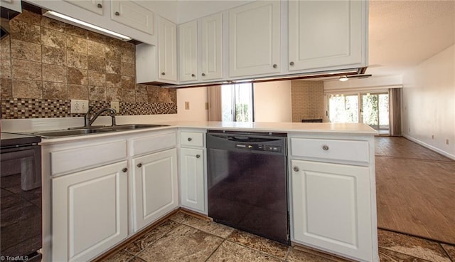 kitchen with sink, kitchen peninsula, white cabinets, and black appliances